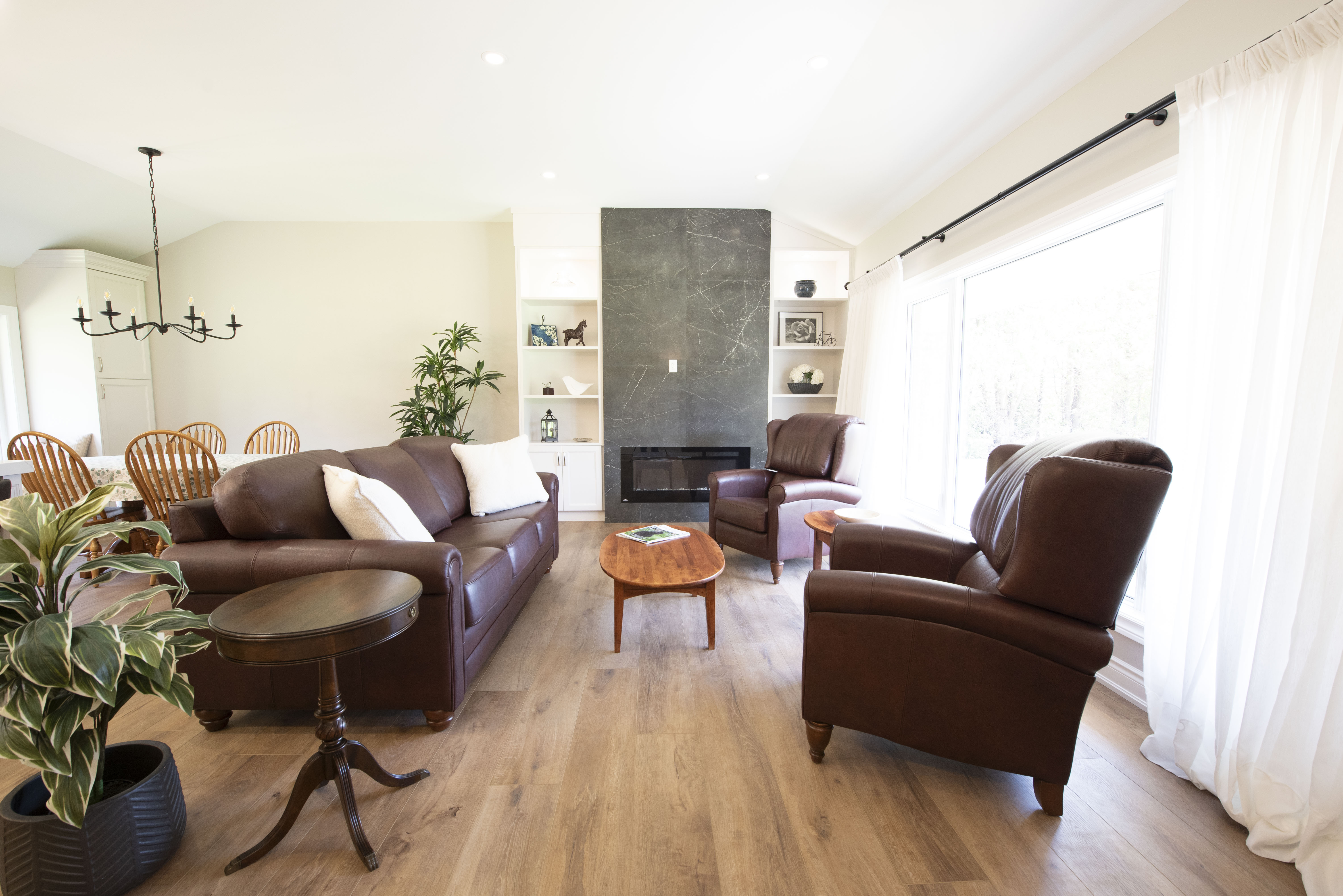 Open plan living room with stone fireplace